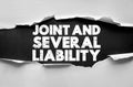 JOINT AND SEVERAL LIABILITY bold text on torn background. Legal term concept referring to shared responsibility for debt or damage Royalty Free Stock Photo