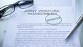 Joint venture agreement approved, seal stamped on official document, business Royalty Free Stock Photo