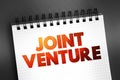 Joint Venture text on notepad, concept background Royalty Free Stock Photo
