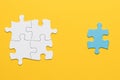 joint white puzzle blue single piece yellow surface. High quality photo Royalty Free Stock Photo