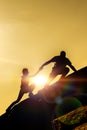 The joint work teamwork of two people man and girl travelers help each other on top of a mountain climbing team Royalty Free Stock Photo