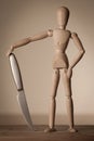 Jointed doll with a knife Royalty Free Stock Photo