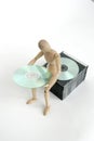 Jointed doll sitting cd stack