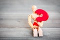 Jointed Wooden Doll hugging red question mark Royalty Free Stock Photo