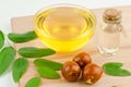 Jojoba oil and fresh jujube fruit on wooden background Royalty Free Stock Photo