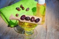 Jojoba oil and seeds on a wood surface