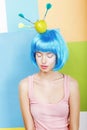 Joke. Eccentric Woman Oddball in Blue Wig with Darts and Green Apple