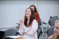 A joke from a physics professor made a student girl laugh very much, she laughs in class, sitting in the audience with Royalty Free Stock Photo
