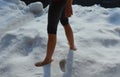 A joke where a friend throws a girl out of the house and lets her stand in the snow without shoes and locks her down. walking on s