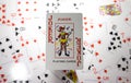 a joker card against the background of other cards that are blurry