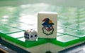 Joker in mahjong tile and a dice on mahjong tiles