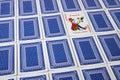 A joker among overturned playing cards facing upwards