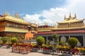Jokhang temple gplden roof in Lhasa, Tibet from distance with a bench Royalty Free Stock Photo