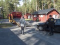 Jokkmokk, Norrbotten, Sweden, Agust 17, 2021: Two men tow truck drivers loading black car onto a tow truck at Arctic