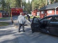 Jokkmokk, Norrbotten, Sweden, Agust 17, 2021: Two men tow truck drivers loading black car onto a tow truck at Arctic Royalty Free Stock Photo