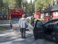 Jokkmokk, Norrbotten, Sweden, Agust 17, 2021: Two men tow truck drivers loading black car onto a tow truck at Arctic Royalty Free Stock Photo