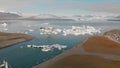 Jokullsarlon glacial lake in southwest Iceland. Aerial view of icebergs in the lagoon, going down from the sky