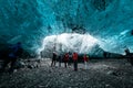 Group of tourists exploring scenery ice cave inside glacier