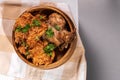 Tasty Nigerian Jollof Rice served and decorated with some green spices and chicken