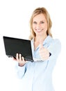 Jolly businesswoman holding a laptop with thumb up Royalty Free Stock Photo