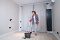 Jolly excited mature woman enjoying cleaning house, she dancing while washing floor. Happy elderly woman enjoying Royalty Free Stock Photo