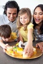 Jolly family eating cookies