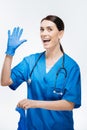 Jolly female doctor dressing in gloves
