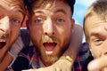 Jolly good fellows. three happy guys enjoying themselves at an outdoor festival.