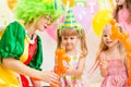 Jolly kids group and clown on birthday party