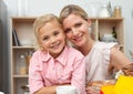 Jolly little girl eating fruit with her mother Royalty Free Stock Photo