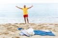 Jolly man resting. Clothes on the sand near sea Royalty Free Stock Photo