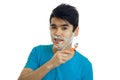 Jolly nice guy with black hair shaves his beard and looks into a camera isolated on a white background