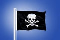 Jolly Roger Pirate flag blowing in the wind Royalty Free Stock Photo