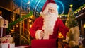 Jolly Santa Claus in His Studio Workshop: Wrapping and Packing Christmas Gifts for all the Good Royalty Free Stock Photo