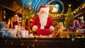 Jolly Santa Claus Works in His Studio Workshop, Wrapping and Packing Christmas Gifts for all the Royalty Free Stock Photo