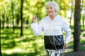 Jolly senior woman enjoying running in forest Royalty Free Stock Photo