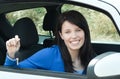 Jolly teen girl sitting in her car holding keys Royalty Free Stock Photo