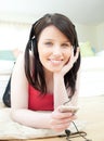 Jolly woman listening music with headphones on lyi