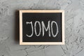 JOMO means Joy of Missing Out Royalty Free Stock Photo