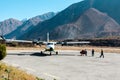 Jomsom, Nepal - November 20, 2017: Airport employees carry luggage to the plane. Jomsom airport in Himalayas mountain early in the