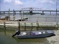 Jon boat with crab traps tied to dock and pushed up on boat land