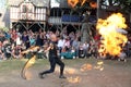 A jongleur performs a dance with burning in flames whips at the annual Bristol Renaissance Faire on September 4, 2010 in Kenosha, Royalty Free Stock Photo