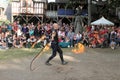 A jongleur performs a dance with burning in flames whips at the annual Bristol Renaissance Faire on September 4, 2010 in Kenosha, Royalty Free Stock Photo