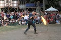 A jongleur performs a dance with burning in flames whips at the annual Bristol Renaissance Faire on September 4, 2010 in Kenosha, Royalty Free Stock Photo