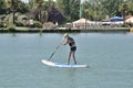 JONZAC,FRANCE-AUGUST 01, 2017: Girl on a stand paddle on the pond of the leisure center of Jonzac