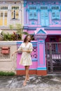Joo Chiat, Singapore- February 2, 2023: Beautiful asian woman in front of Colourful Peranakan House.