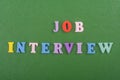 JOP INTERVIEW word on green background composed from colorful abc alphabet block wooden letters, copy space for ad text. Learning