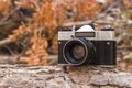 Jordan, Amman, 08/10/2017. Old film camera SLR Zenith with lens Helios-44M on a branch in the forest