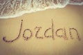 Jordan title on the sand beach of the coast Red sea