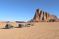 Group of tourists rides on pickup truck through Wadi Rum desert Royalty Free Stock Photo